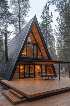 a - frame cabin in the woods with wooden decking