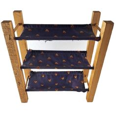 three tiered wooden shelf with blue fabric on it