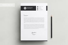 a white and black letterhead next to a pencil