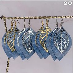 four blue cloths with gold leaf designs hanging from a rope