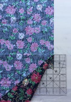 a piece of fabric with flowers on it next to a ruler