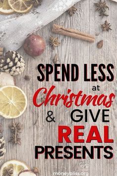 the words spend less at christmas and give real presents on a wooden background with lemons, cloves, anise