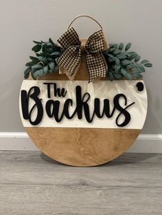 a wooden sign that says the backus hanging on a wall next to a door