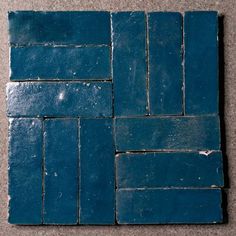 several blue tiles laid out on the floor