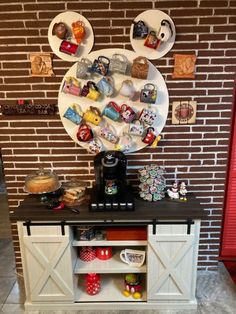 a coffee bar with plates and cups on the wall above it, along with other items