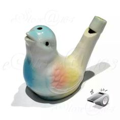 a ceramic bird figurine sitting next to a roll of toilet paper