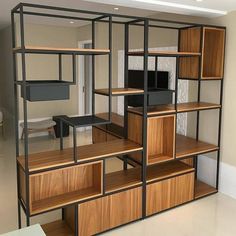 a room with shelves, desks and computers on them in the middle of it