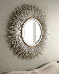 a round mirror hanging on the wall