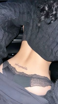 the back of a woman's neck with an inscription on her left side that reads, miserableate