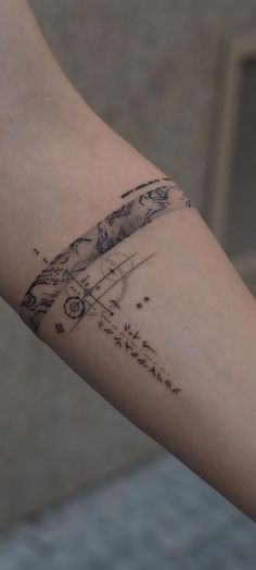 a woman's arm with a tattoo on it that has an airplane flying in the sky