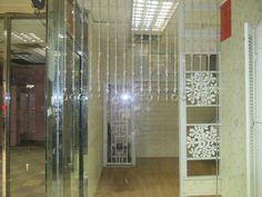 the inside of an office building with glass walls and decorative designs on the doors, windows, and shelves