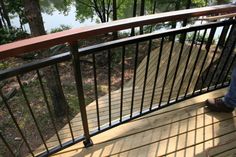 a person standing on a wooden deck next to a lake