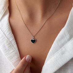 This elegant black heart necklace is crafted with 14k solid gold, embodying timeless beauty and sophistication. Its minimalist design, combined with the finest craftsmanship, makes it a perfect piece for everyday wear or a meaningful gift for a loved one. This necklace is crafted with real 14k solid gold(not plated, not vermeil, not gold filled) You don't need to worry about water, perfume or conditioner contact since real gold doesn't tarnish. The center is hand applied black enamel on top of solid gold for the design purpose, hot applied enamel is the best and most resistant type of application in which enamel and gold bond together over extreme temperatures. This ensures that your piece keeps its beauty for decades to come. You can even wear this piece in water as well. Minimalist Heart Cut Jewelry With Polished Finish, Minimalist Heart Cut Polished Jewelry, Black Sterling Silver Tarnish Resistant Necklace, Black Enamel Necklace For Anniversary, Black Necklaces For Anniversary On Valentine's Day, Black Necklace For Anniversary On Valentine's Day, Dainty Black Tarnish-resistant Jewelry, Valentine's Day Black Necklace For Anniversary, Black Enamel Fine Jewelry Necklace