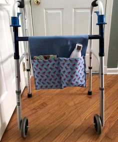 a blue and white folding walker with two handles on the handlebars is sitting in front of a door