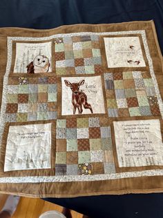 a quilted blanket with pictures of animals and words written on the front, sitting on a table