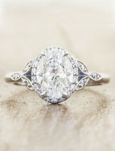 an oval cut diamond ring with two side stones