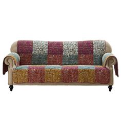 a couch that is covered in some colorful fabric and has an intricate design on it