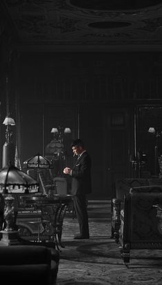 a man standing in a room with lots of furniture