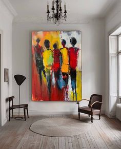 an abstract painting hangs on the wall above a chair