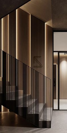 an elegant staircase with black railings and wooden panels on the wall, leading to another room