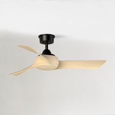 a black ceiling fan with wooden blades on it