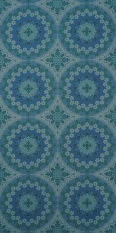 a blue and green background with circular designs on it's surface, in the middle of