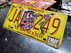 a yellow license plate with an image of a demon on it