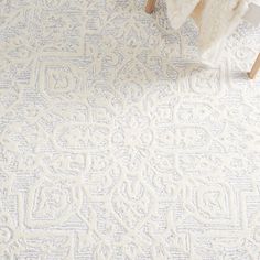 a white rug with an intricate design on it