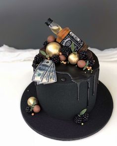 a black hat with gold decorations and money on the top that is covered in chocolate