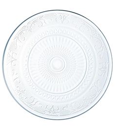 a white plate with an intricate design on the center and bottom, in front of a white background