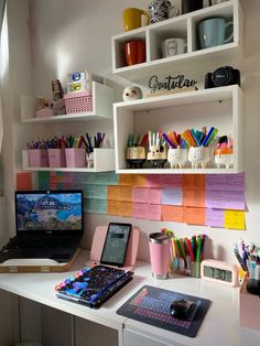 a laptop computer sitting on top of a white desk