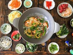 a table topped with lots of different bowls and plates filled with food on top of it