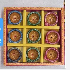 an open box filled with different types of doughnuts on top of a table