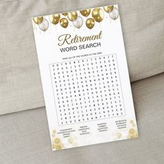 a printable word search is displayed on a couch with gold and white balloons in the background