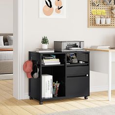 an office area with a desk, printer and bookshelf