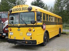 two yellow school buses parked next to each other