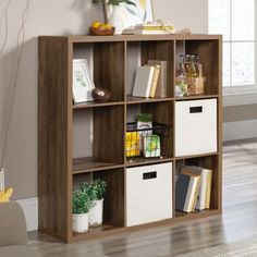 a book shelf with baskets and books on it