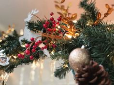 a christmas tree with pine cones and red berries