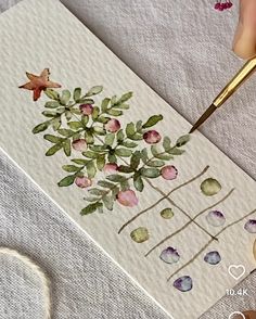 someone is painting flowers with watercolors on paper