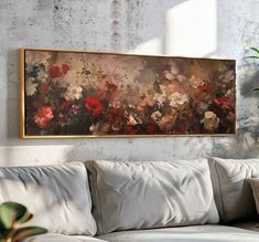 a painting hanging on the wall above a couch