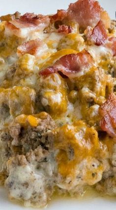 a white plate topped with meat and cheese covered casserole