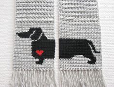 two black and white crocheted afghans with a dog on it's side