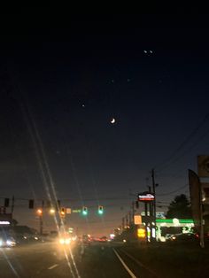 cars driving down the road at night time