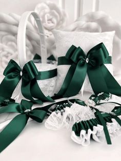 two wedding garters, one with green ribbon and the other white