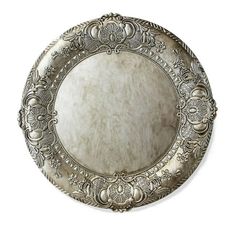 an antique silver plate with ornate designs on the rim and sides, isolated against a white background