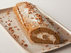 a loaf of bread is sitting on a plate with powdered sugar sprinkles