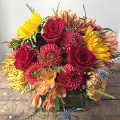 a vase filled with red and yellow flowers