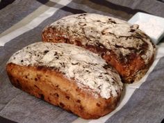 two loaves of bread sitting on top of a checkered table cloth