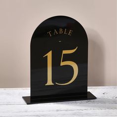 a black and gold table number holder