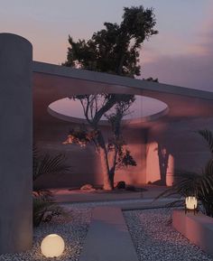 an outdoor area with rocks and plants at dusk